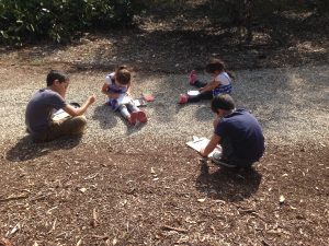 The older kids couldn't resist joining the younger in their 'A' studies for the day. Here they all sit right in the middle of the Australian Gardens looking over what they have to find next on their scavenger hunt.